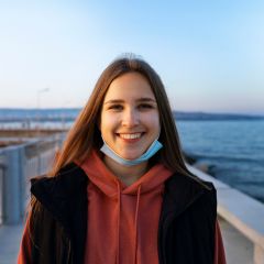 front view smiley woman seaside 1